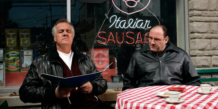 tony soprano and paulie walnuts sit outside satriales